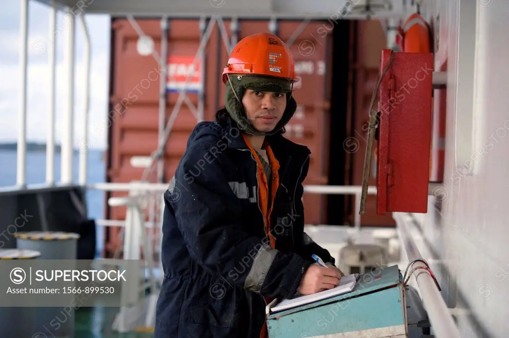 An Indonesian seaman or sailor on the container-vessel MV Flintercape, during a journey from Rotterdam, Netherlands, to Sundsvall, Sweden. The man is ...