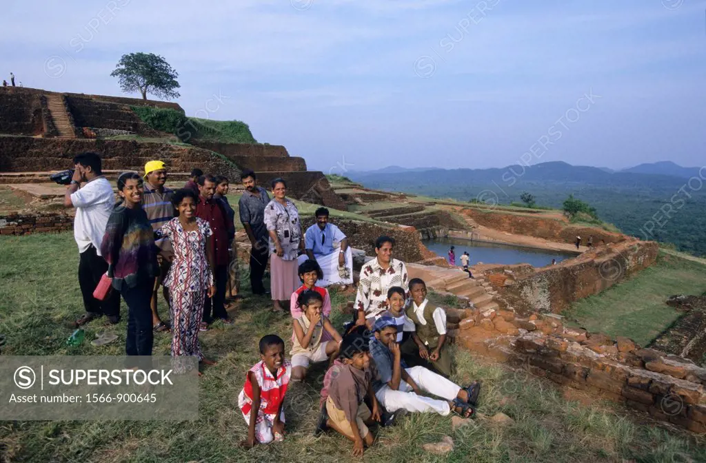 Local family visiting summit of old royal palace vestiges, Sigiriya Lion´s rock fortress, Sri Lanka