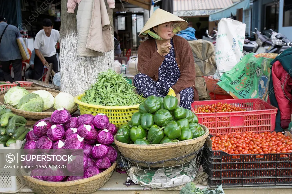 Woman in conical hat selling vegetables Dalat south east Vietnam