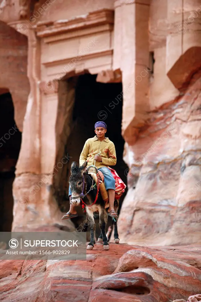 Portrait of a young beduin man riding a donkey, Petra, Jordan