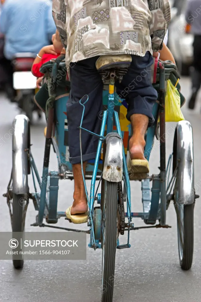 Rear view of cyclo rickshaw and driver Ho Chi Minh City Vietnam