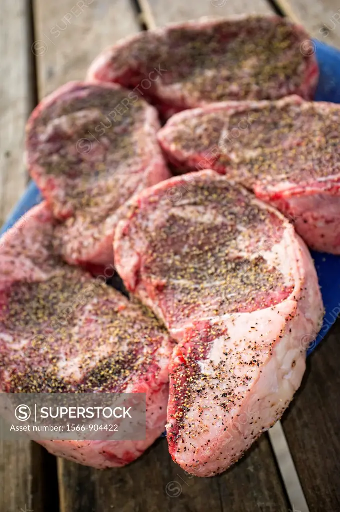 Beef Ribeye Steaks seasoned with salt and pepper, ready to grill