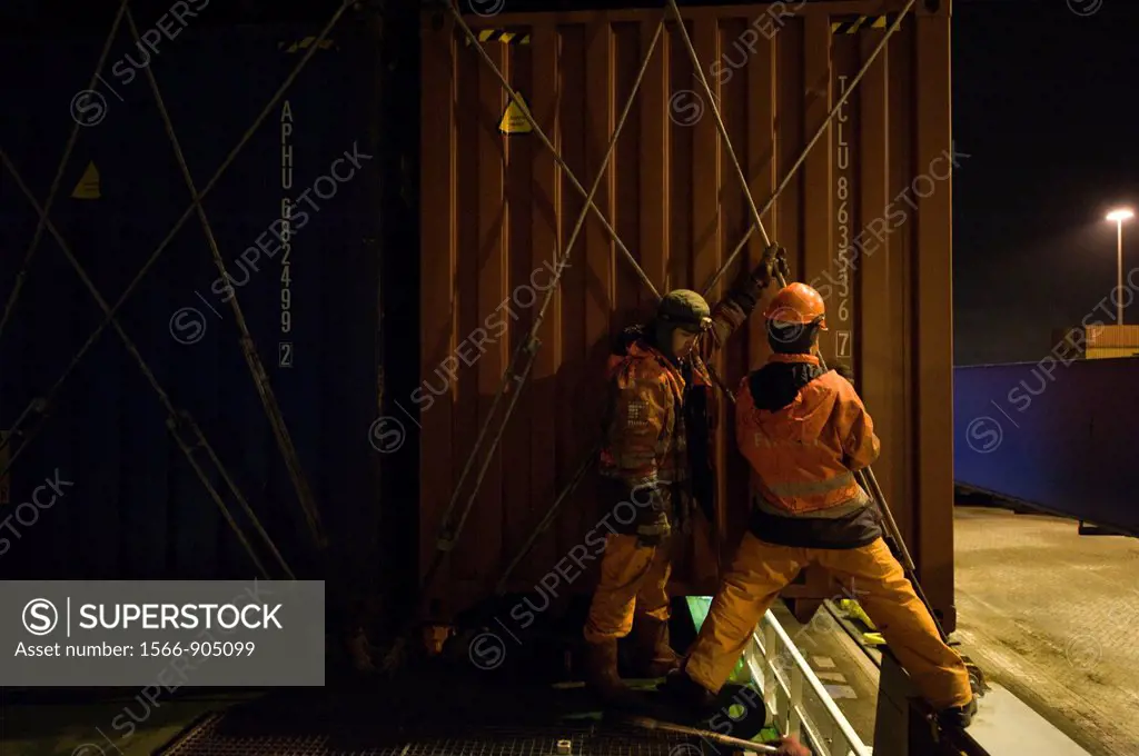 Two ´Able Seamen´ or sailors are receiving and placing new containers on the deck of container-vessel MV Flintercape, who sails from Rotterdam, Nether...