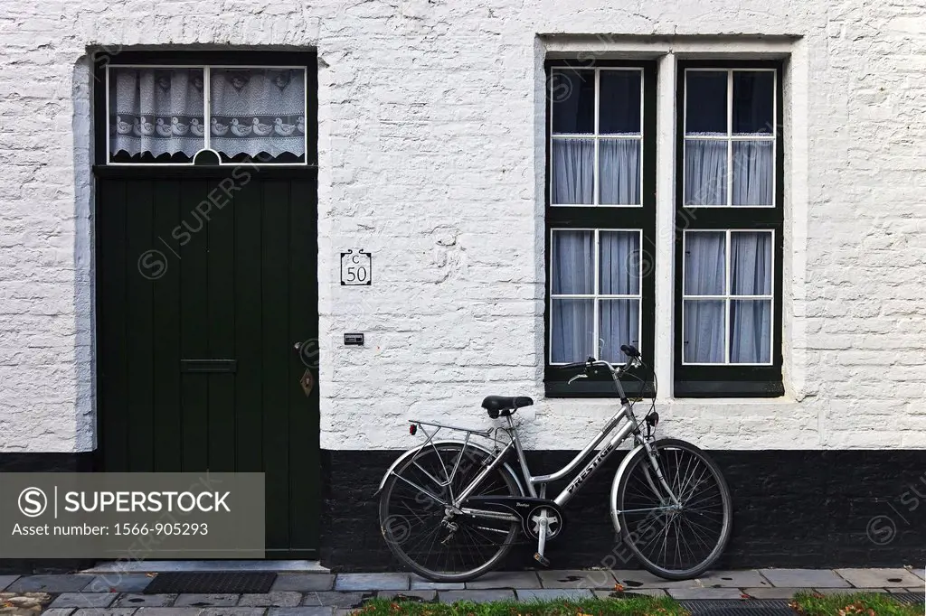 Traditional architectural door and window detail of a Beguinage, with a bike in Brugge Sint Michiels, Brugge Bruges, Belgium