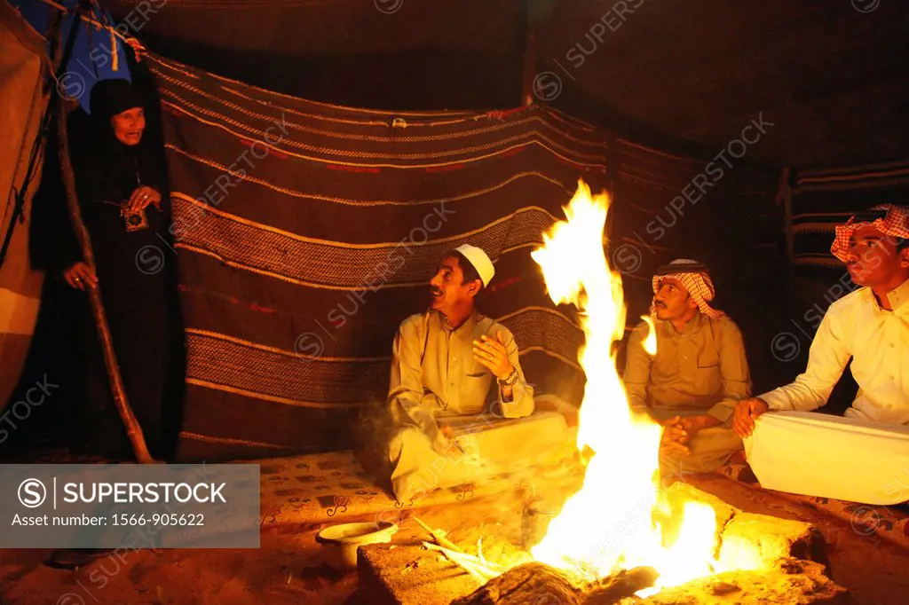 Bedouins sitting around the fire in their camp, Wadi Rum, Jordan
