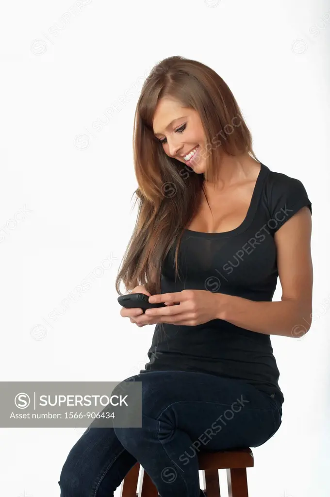 Young woman texting on cell phone