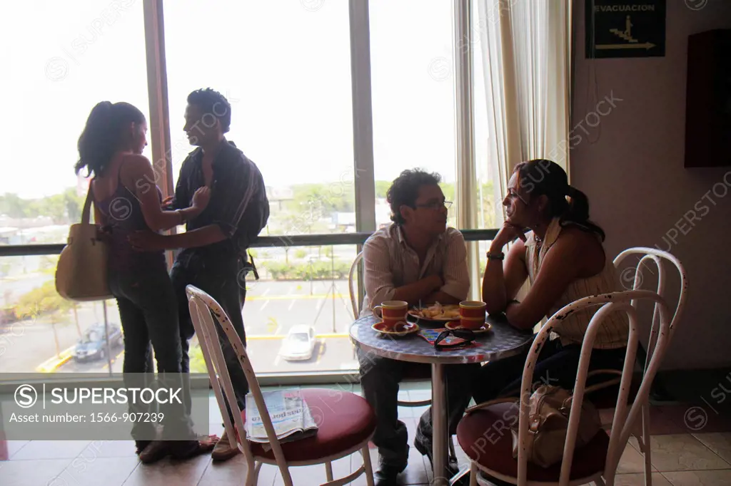 Nicaragua, Managua, Avenida Simon Bolivar, Plaza Inter, shopping mall, food court, coffee shop, window, table, chair, Hispanic, man, woman, couple, ro...