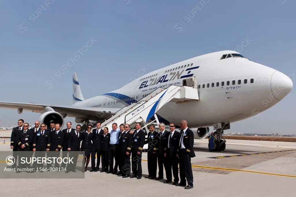 El Al flight crew stand with Eliezer Shkedi El Al CEO centre in front of a Boeing 747 passenger plane