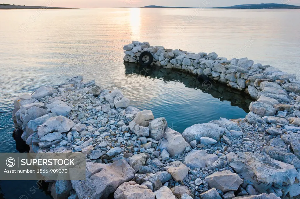 Colorful late sunlight in a very small harbor, Pag island in Croatia