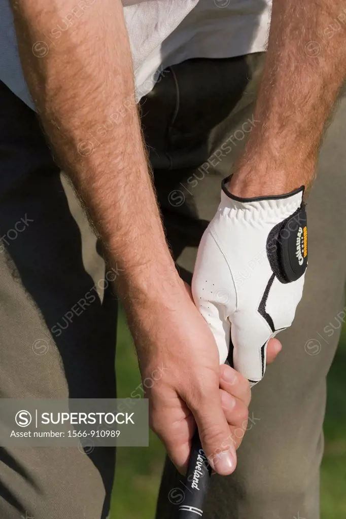 Male golfer demonstrating correct grip on handle of club