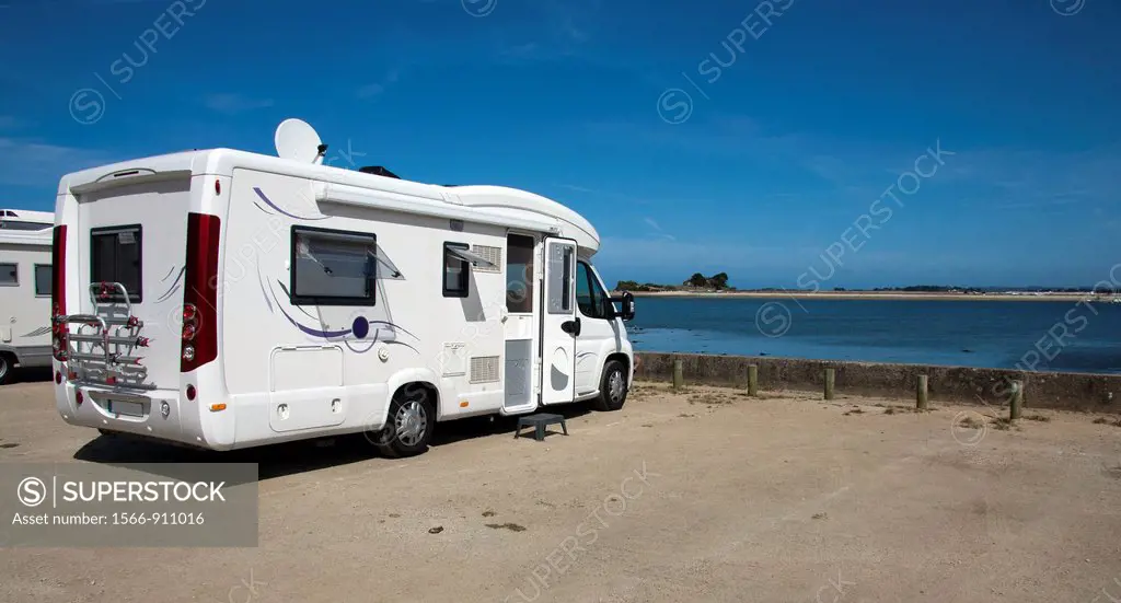 Camper at the edge of the sea and blue sky