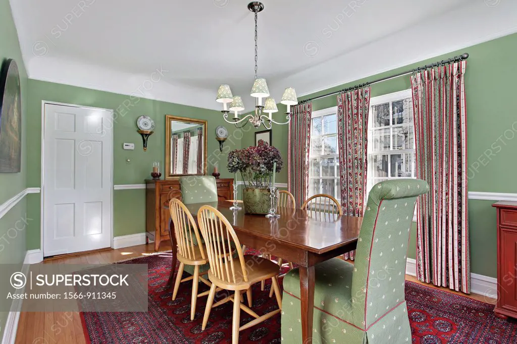 Dining room in suburban home with green walls