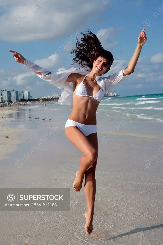 woman jumping seaside
