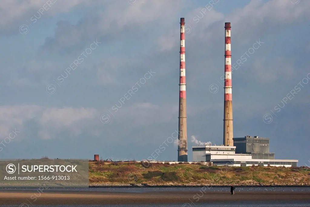 Ireland, Dublin, Sandymount, Ringsend, The twin chimney towers of Ringsend Powerstation Ireland, with Dublin Bay / Sandymount Strand in the foreground
