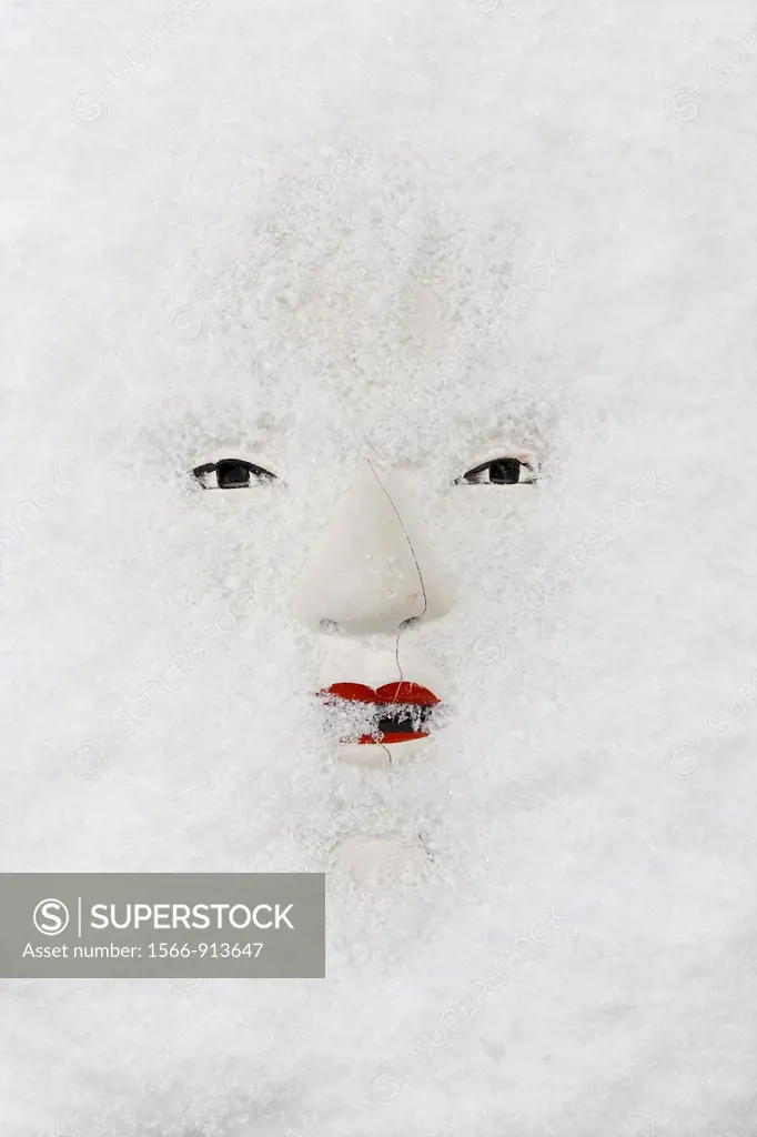 traditional but broken japanese noh theatre mask of ko-omote representing young beauty woman in snow - symbolism of growing older dead slowly but sure...