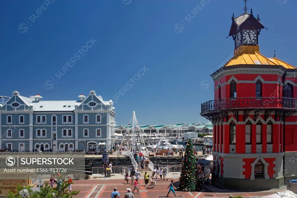 Old warehouse with bridge, Clock Tower, Victoria Wharf and people at waterfont, blue sky, sunny day, Cape Town, South Africa