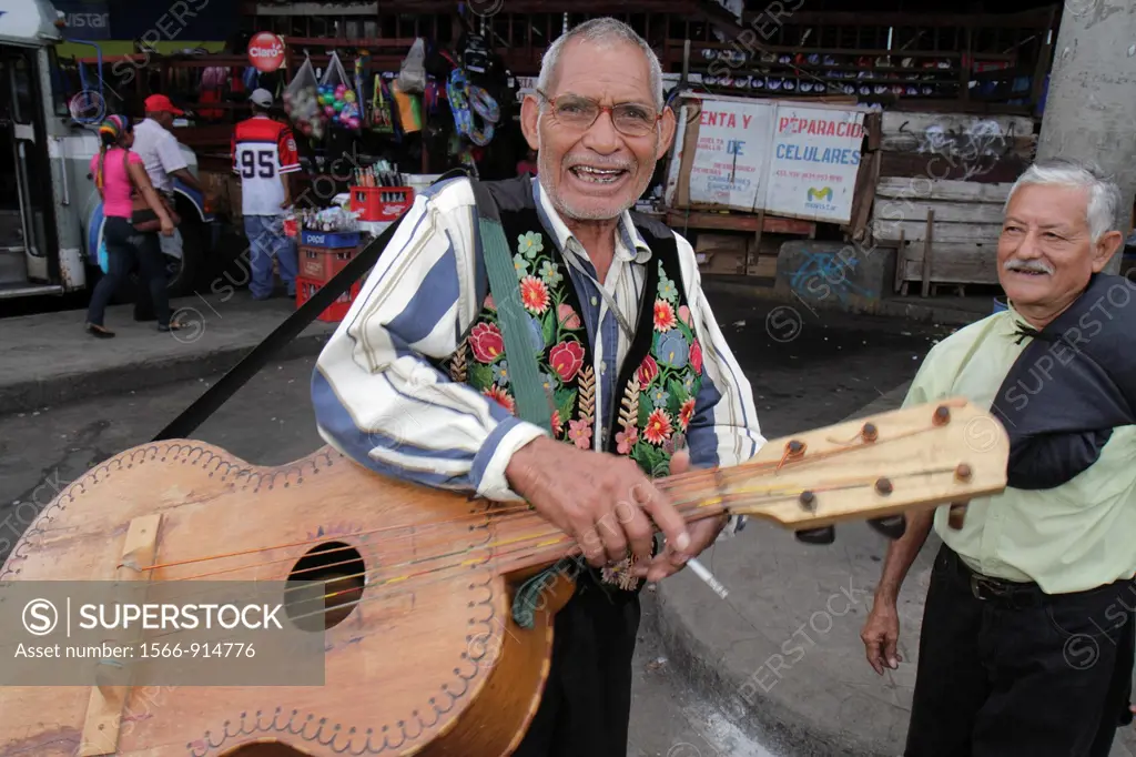 Nicaragua, Managua, Mercado Roberto Huembes, market, marketplace, shopping, street performer, musician, Hispanic, man, men, senior, homemade guitar, s...