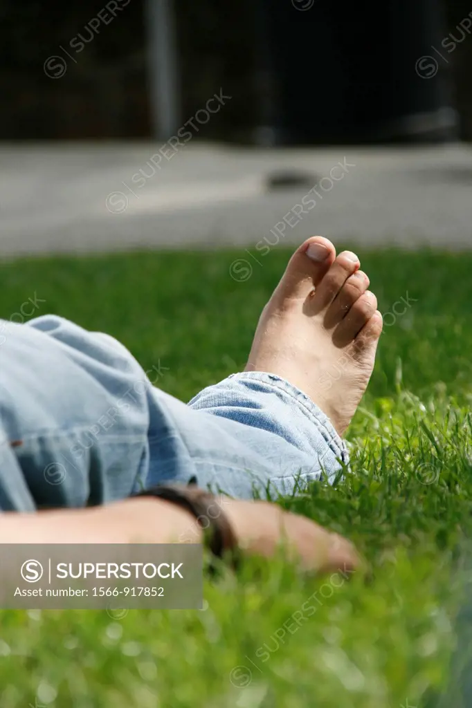 one man sleeping on lawn grass in park