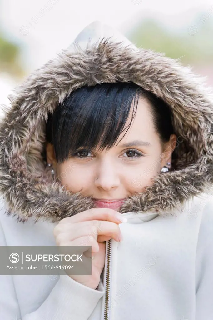 Young woman is warm under her jacket hood