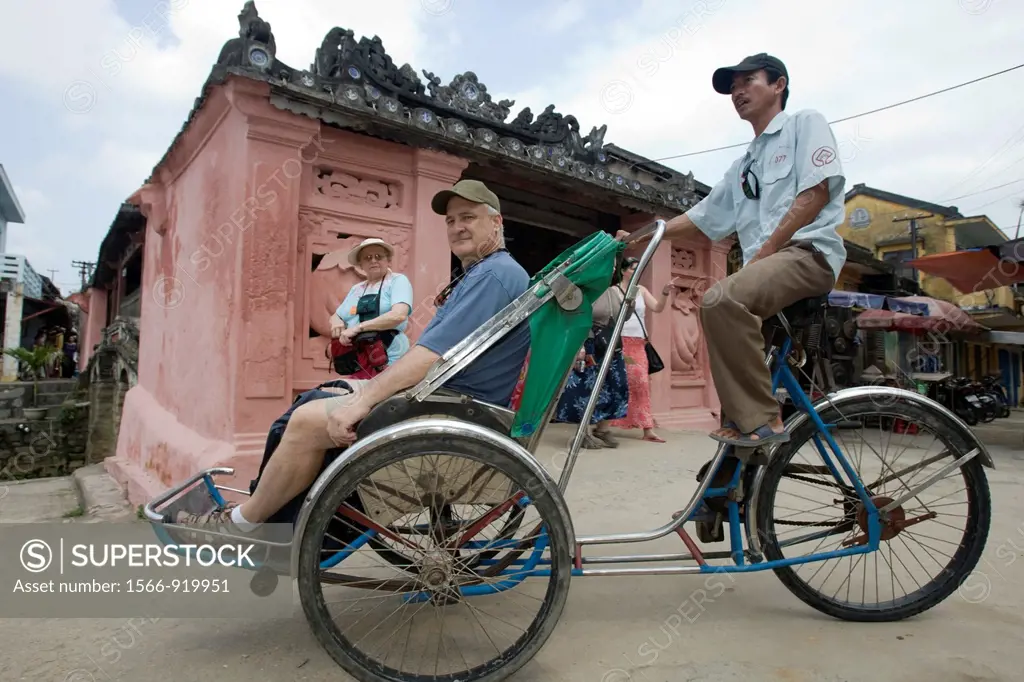 Tourist rickshaw at landmark Japanese Covered Bridge Hoi An Vietnam