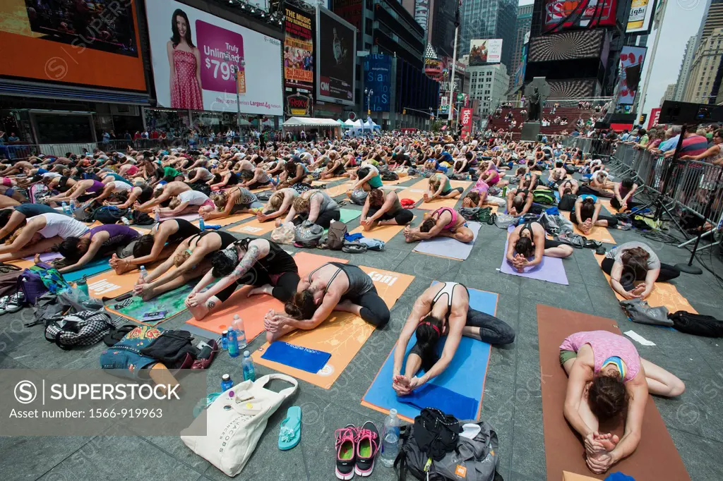 Thousands of yoga practitioners in Times Square in New York participate in a group Bikram Yoga class observing the Summer Solstice The classes given t...