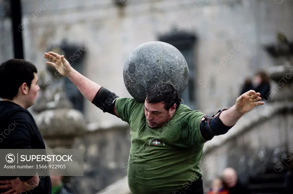 Juan Jose Unanua ´Goenatxo´, stone lifter or harrijasotzaile in Basque language  Exhibition in Azkoitia where he lifts a heavy round stone and moves i...