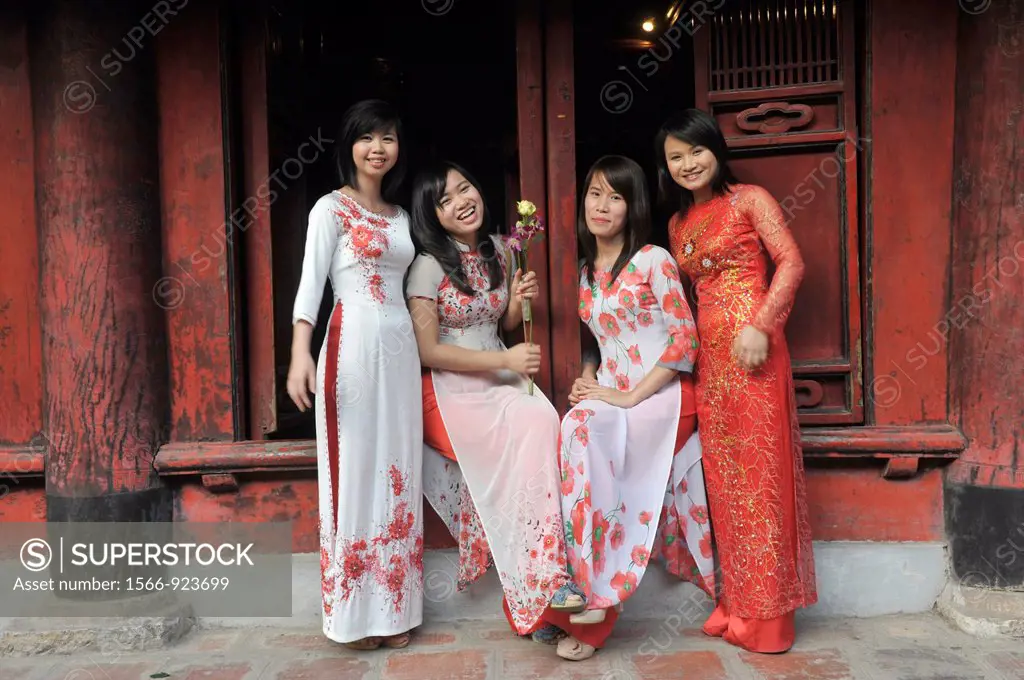 Asia,South East Asia,Vietnam,women in traditional dress posing in front of the Temple of Literature in Hanoi