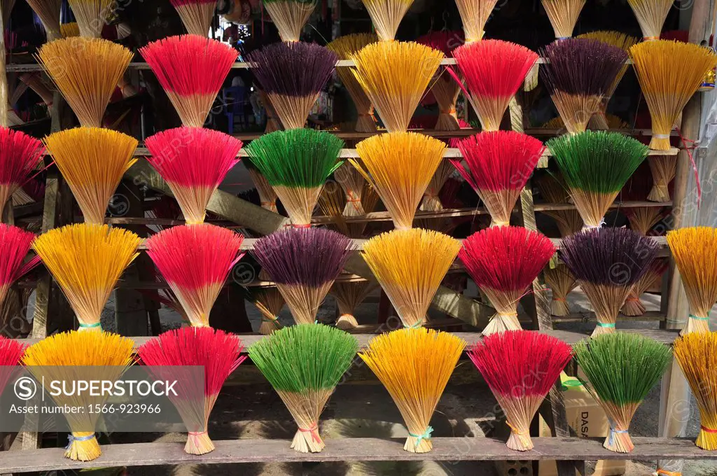 Asia,South East Asia,Vietnam,Rows of colorful incense sticks lined up in a roadside stall near Hue
