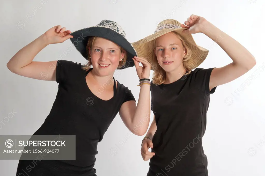 Two teenage girls with hats