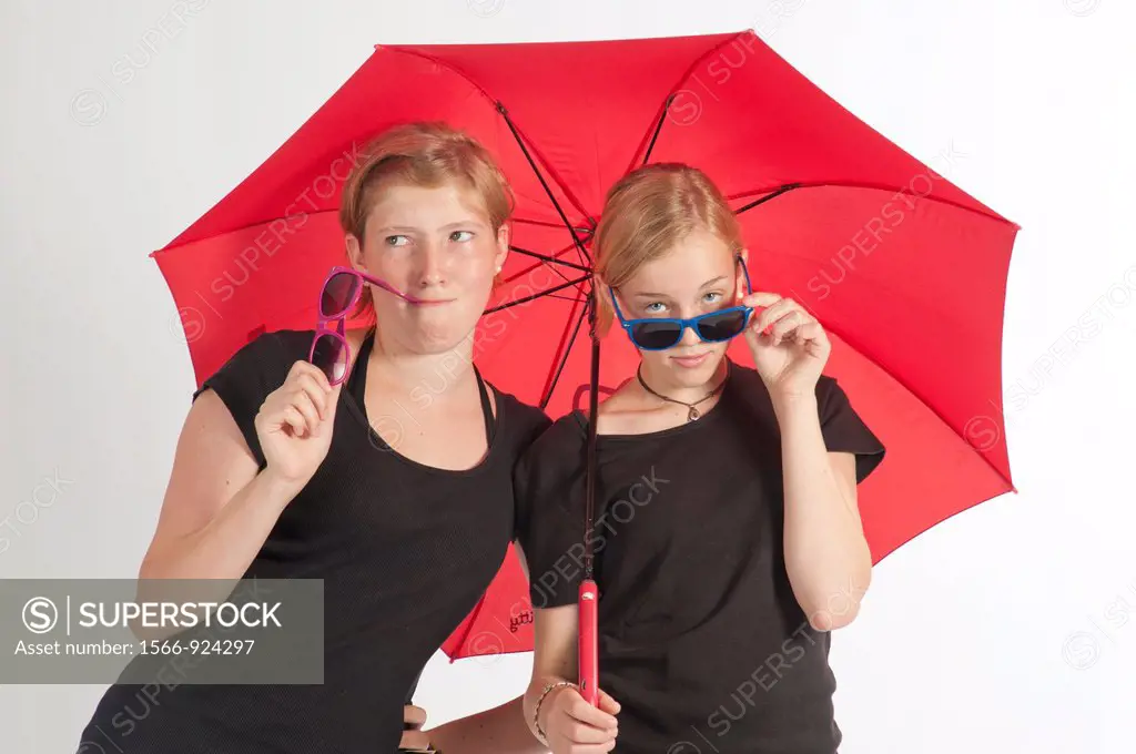 Two young German girls under an umbrella.