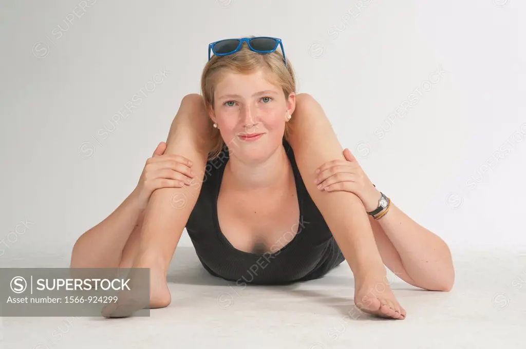Blonde girl lying on the floor simulating bodily contortions.