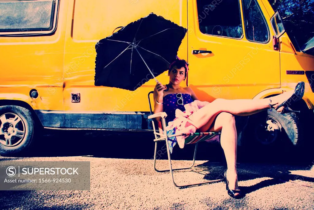 Fashion picture of a girl with an umbrella, from a whole series with a yellow van.