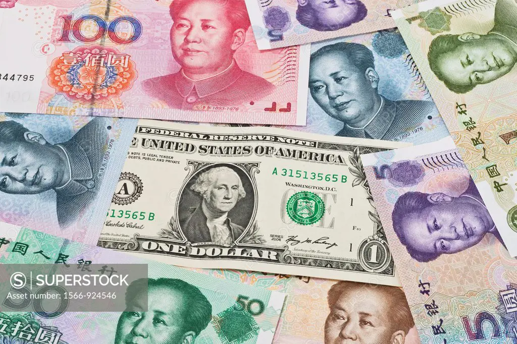 Many Yuan bills with the portrait of Mao Zedong lying side by side In the middle lies a 1 U S Dollar bill The renminbi, the Chinese currency, was intr...