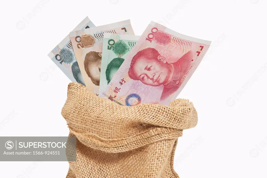 Many diverse Chinese Yuan bills with the portrait of Mao Zedong are in a jute bag The renminbi, the Chinese currency, was introduced in 1949 after the...