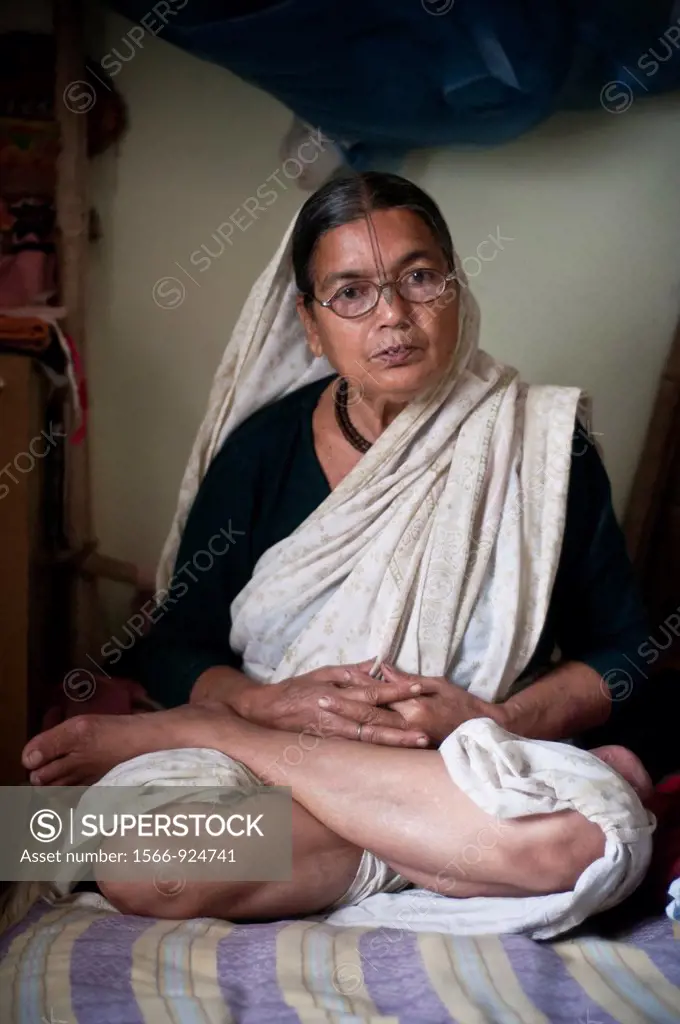 Portrait of a middle aged woman in lotus pose, Vrindavan, Uttar Pradesh, India