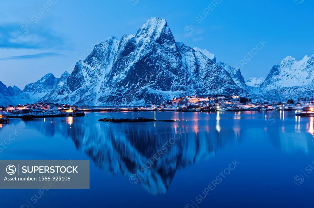 Reflection of Olstind mountain peak in harbour at Reine, Lofoten Islands, Norway