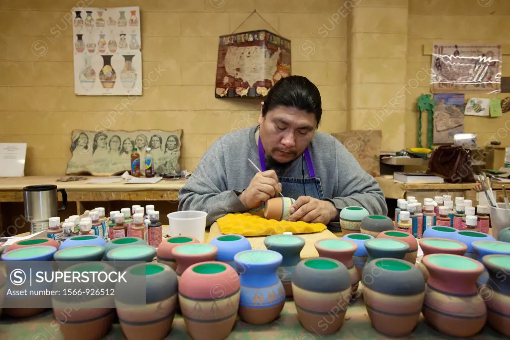 Rapid City, South Dakota - Dorian New Holy, a member of the Oglala Sioux, creates pottery at Sioux Pottery