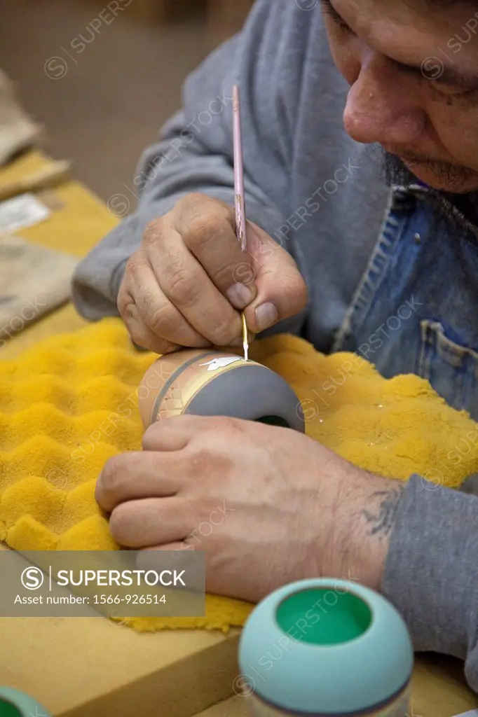Rapid City, South Dakota - Dorian New Holy, a member of the Oglala Sioux, creates pottery at Sioux Pottery