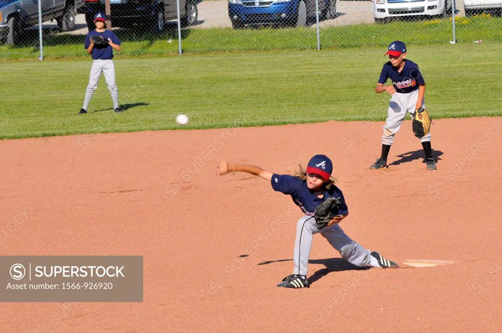 Little League baseball pitcher throwing baseball