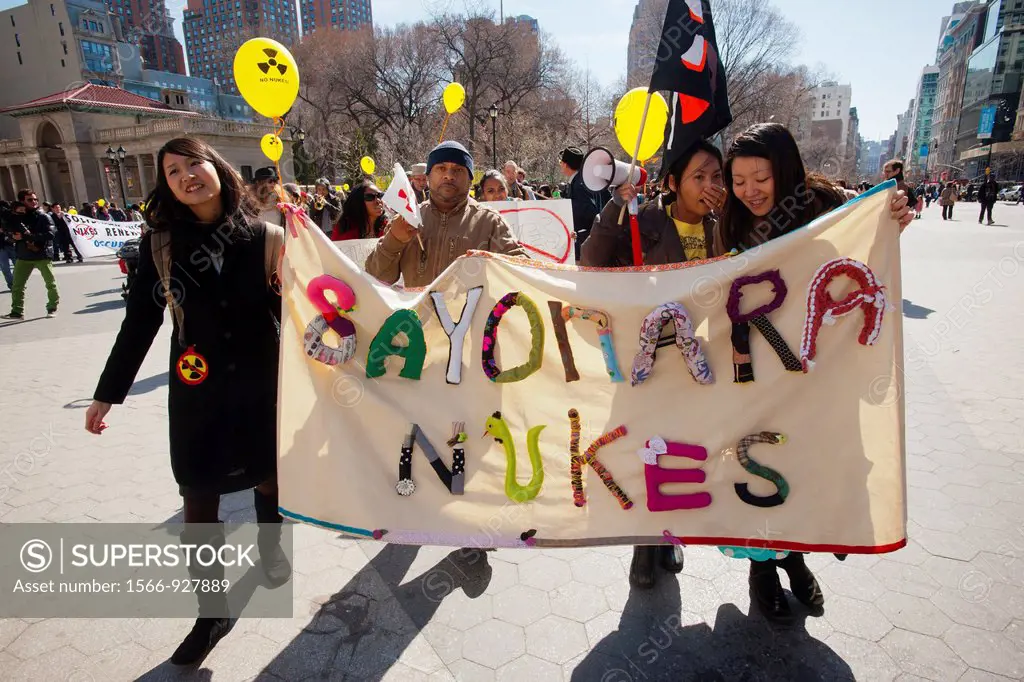 On the first anniversary of the Fukushima nuclear plant disaster in Japan, Sunday, March 12, 2012, activists in New York gather in Union Square Park t...