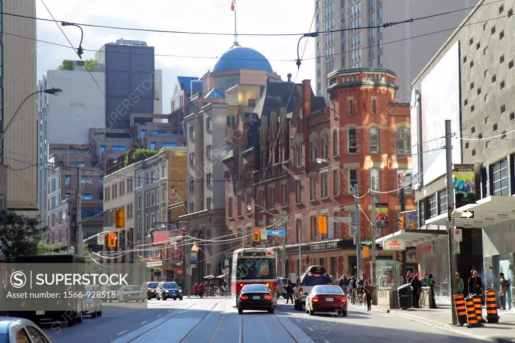 Canada, Ontario, Toronto, Carlton Street, College Street, Yonge Street, main thoroughfare, street scene, electric streetcar, power wires, passenger ra...