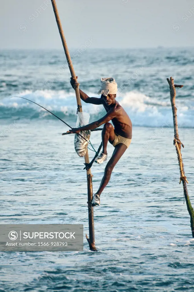 stilt fisherman on his pole in the Indian Ocean, an age old tradition in Midigama, Sri Lanka