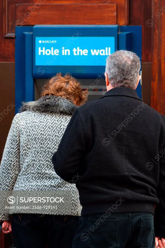 People using local cash Barclays ´Hole in the Wall´ cash machine, England, UK