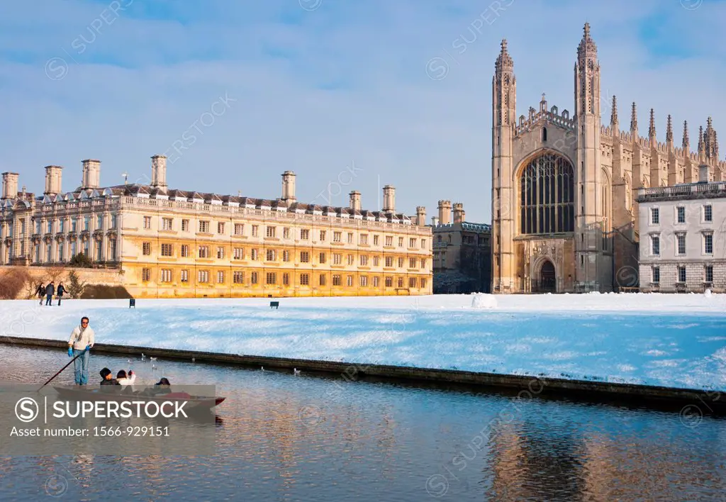 Punting along river Cam in winter snow with Kings College Chapel to the rear  Cambridge, England