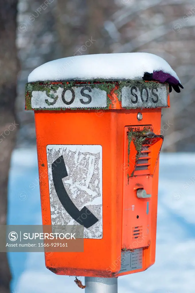 Snow covered SOS telephone, emergency telephone, call distress, Munich, Germany