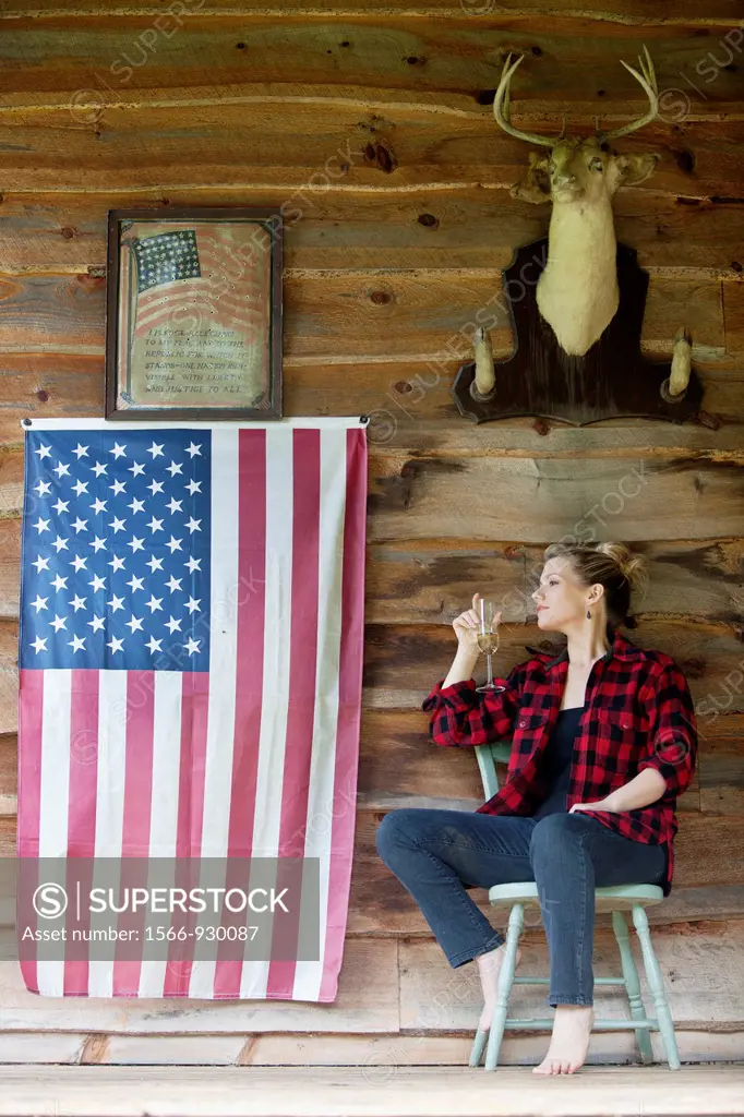 Woman sitting on porch drinking champagne