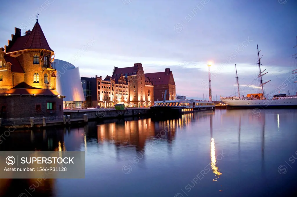 blue hour at the harbor with the building of the Maritime pilots, Ozeaneum and the three-mast barque Gorch Fock 1 in the Hanseatic City of Stralsund, ...