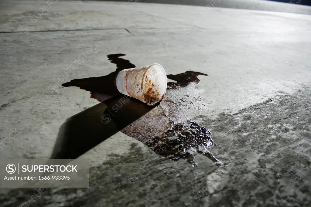 one spilled coffee cup in street road in city town at night