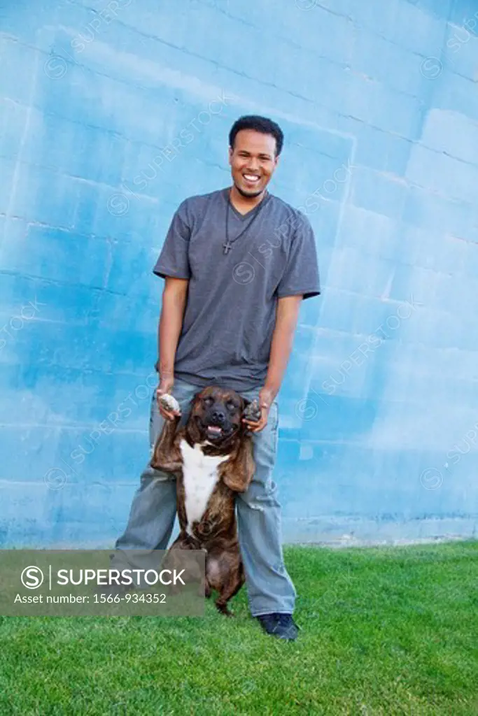 A young African-American man with his pitbull in Spokane, Washington, USA