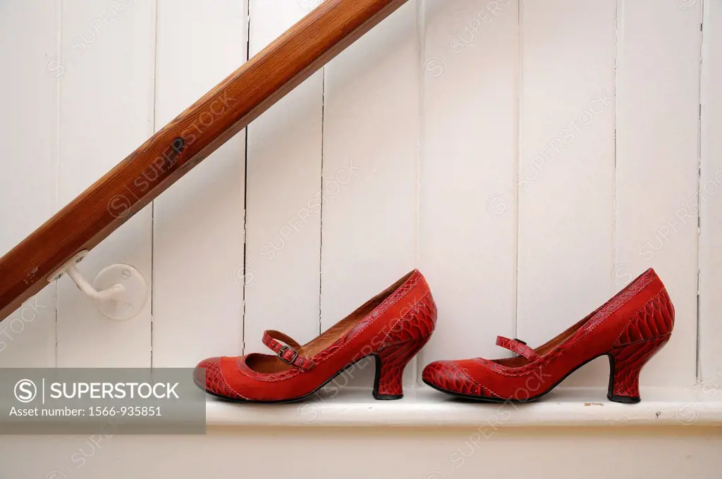Red shoes on white wall